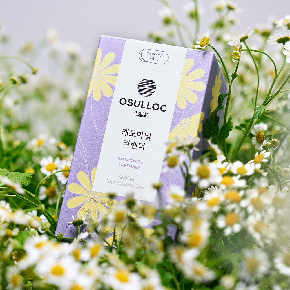 OSULLOC Chamomile Lavender Tea (20 count) packaging in a field of flowers, highlighting its caffeine-free floral blend.
