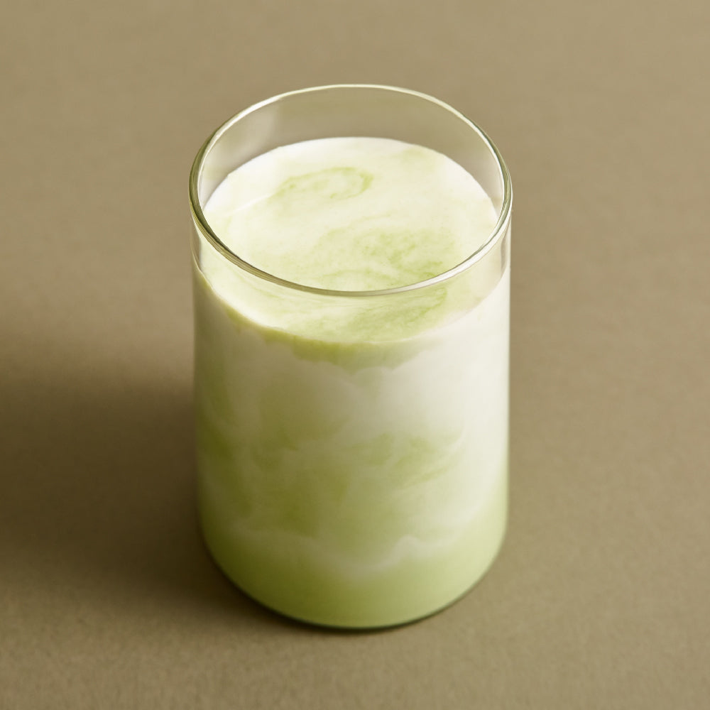 Osulloc Matcah Mania Bundle matcha drink in a clear glass with layered green and white hues.